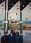Family picture in front of sign for Smaland